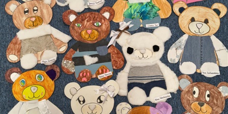 Powiększ grafikę: Prace plastyczne-  kolorowe misie wyklejone tkaninami, piankami itp. leżą na dywanie.