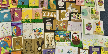 Powiększ grafikę: Kilkadziesiąt prostokątnych kartek wielkanocnych ułożonych obok siebie.
