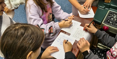 Powiększ grafikę: Grupa dzieci rozwiązuje zadania dotyczące quizu wiedzy o kalendarzu.