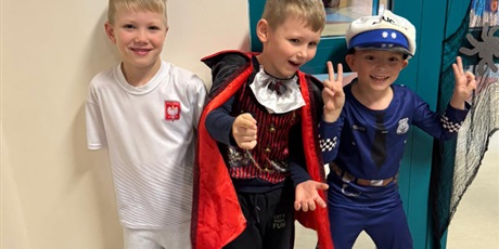 Powiększ grafikę: Chłopcy przebrani z drakulę, piłkarza i policjanta bawią się na balu. Tańczą i się śmieją.