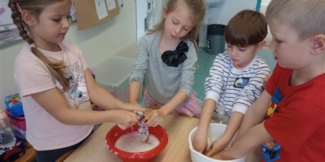 Powiększ grafikę: Grupa dzieci w misce pierze ubrania.