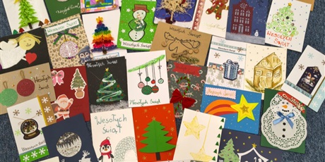 Powiększ grafikę: Kolorowe kartki bożonarodzeniowe leżą na dywanie. Są na nich namalowane bombki, choinki, bałwanki itp.