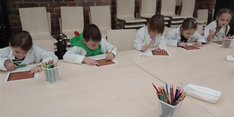 Powiększ grafikę: Dzieci wykonują zadanie na keatkach papieru. Pracują w skupieniu.